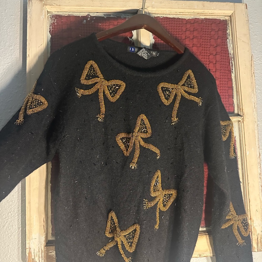 Chic Black Sweater with Gold Bow Details